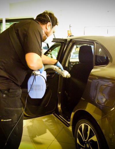 Applying product to rear left seat area - shows mist from fogger