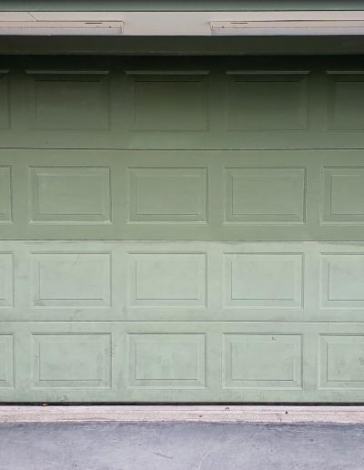 Top section of garage door cleaned ready for coating with test area