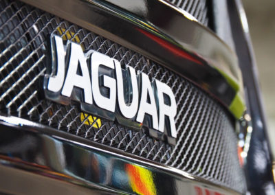 Jaguar badge with coating on it