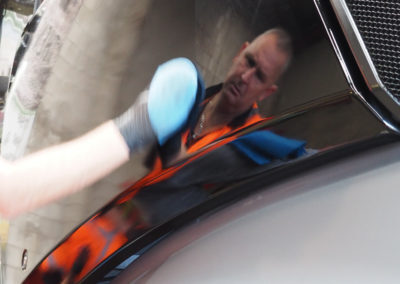 Operator applying paint protection coating
